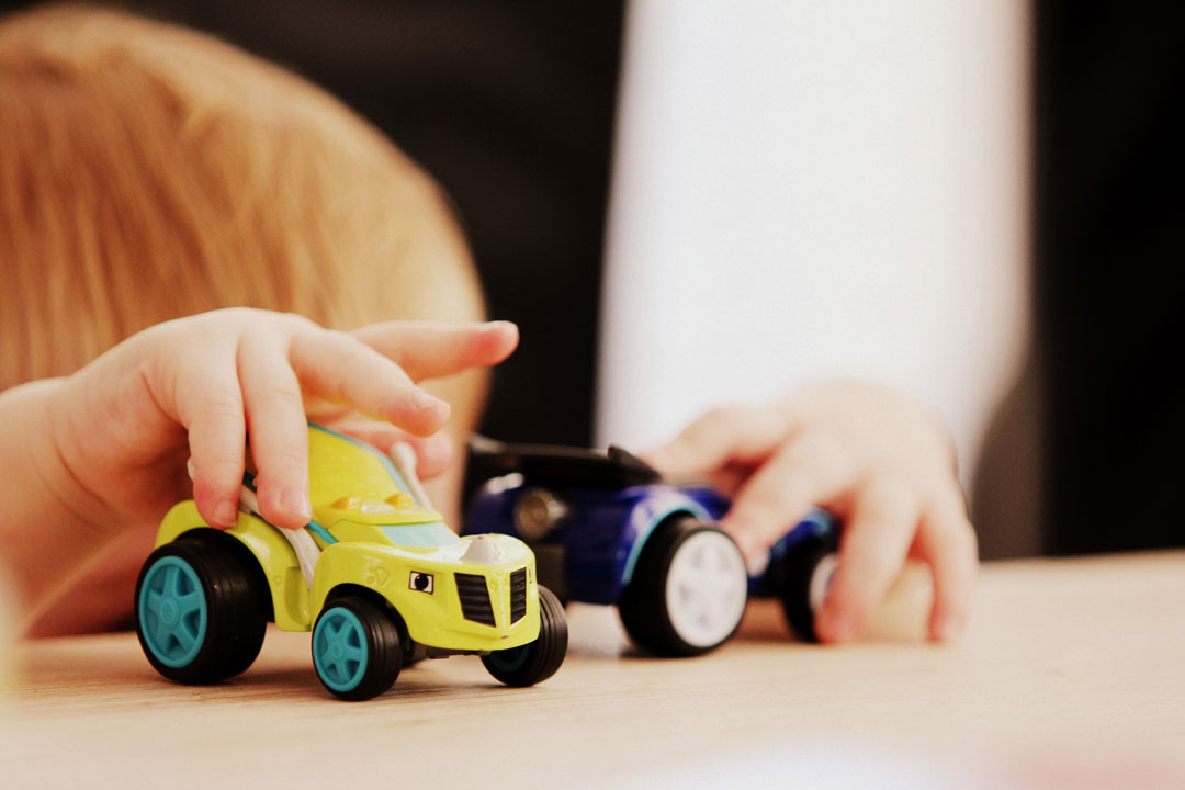 Child playing with cars