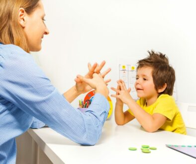 Child engaging in developmental milestones activity with a parent during a play session.