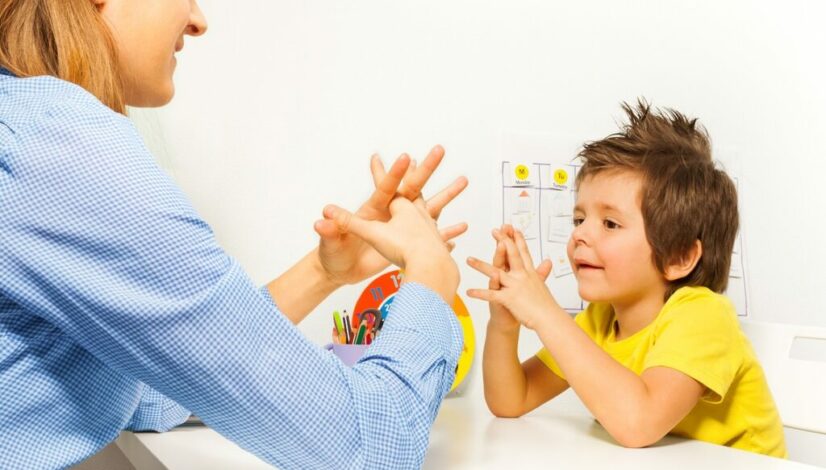 Child engaging in developmental milestones activity with a parent during a play session.