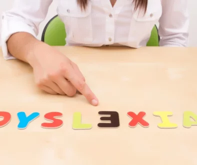 a child playing with alphabet letters spelling out dyslexia