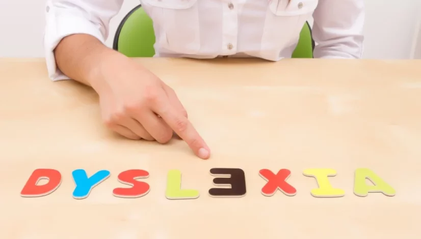 a child playing with alphabet letters spelling out dyslexia