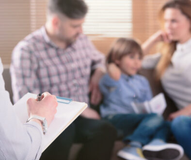 Hand,Of,A,Professional,Family,Psychotherapist,Writing,Notes,In,Front