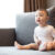 Infant sitting on a sofa showing early developmental behaviors and expressions, a topic covered in recognizing the early signs of autism in infants